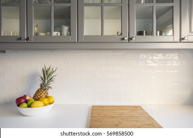 Kitchen With White Worktop, Grey Furniture And Brick Tiles