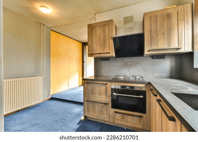 a kitchen with wood cabinets and an oven on the counter in front of the stove top is empty, but there is no one