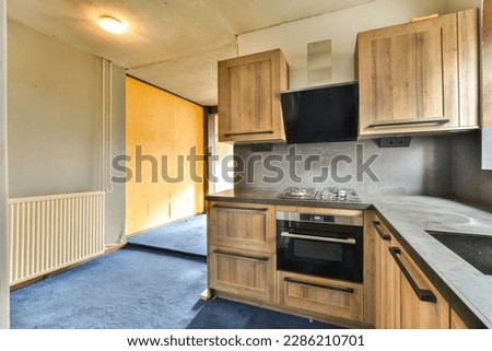 a kitchen with wood cabinets and an oven on the counter in front of the stove top is empty, but there is no one