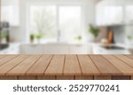 Kitchen wood table top for product display with blurred modern interior. Wooden tabletop over defocused kitchen background. kitchen furniture and desk space. product promotion in the kitchen