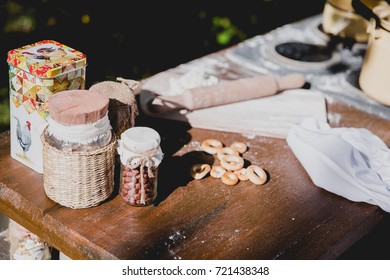 kitchen wooden work surface with cans, flour test and rolling pin