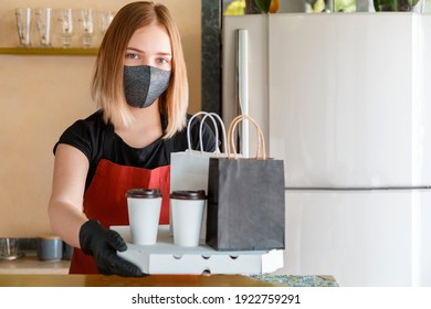 Kitchen Worker Portrait Issues Online Orders In Gloves And Mask. Takeaway Food Paper Bag Mock Up. Food Bag, Pizza, Drink Package To Go In Takeaway Canteen. Contactless Food Delivery Lockdown Covid 19.