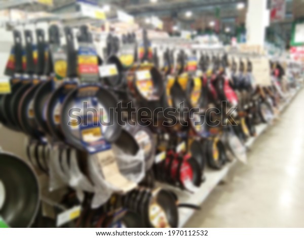 kitchenware department on blur background,\
Picture of Shelves with stainless steel pots on blur effect style,\
Blurred abstract skillet and frying pants on display at cookware\
department.