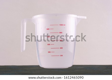 Kitchenware. Measuring cup with water.