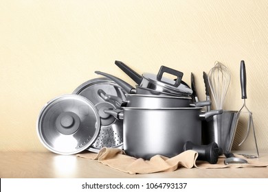 Kitchenware prepared for cooking classes on table against light wall - Shutterstock ID 1064793137