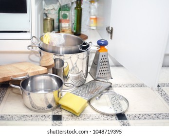 Kitchenware Spread Out On A Floor And Open Kitchen Cupboard