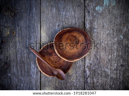 Kitchenware, wooden stump or natural style wooden coaster and spoon on wood table background