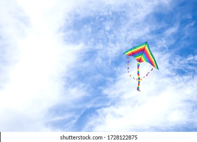 
kite in hand on blue sky in sunny weather and wind. Kite flying in summer with copy space. 
Freedom. Summer games and fun - Shutterstock ID 1728122875