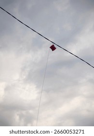 Kite string spool caught on wire above the rooftop.