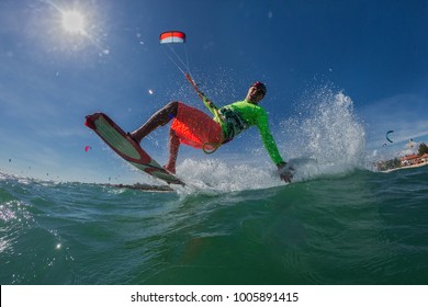 A Kite Surfer Rides The Waves