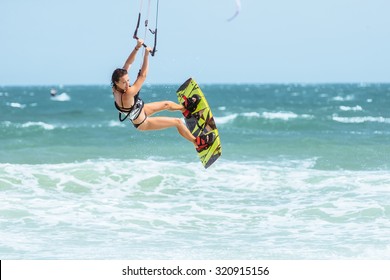 A Kite Surfer Rides The Waves.