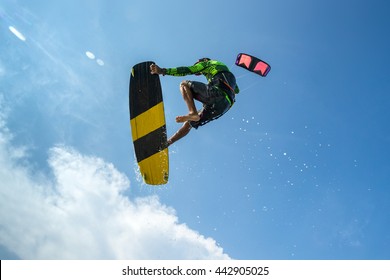 A Kite Surfer Rides The Waves