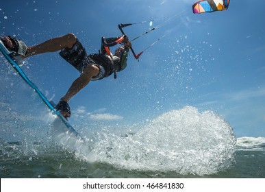 A Kite Surfer Rides The Waves