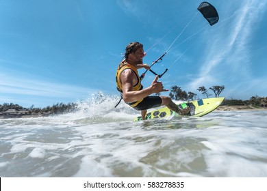 A Kite Surfer Rides The Waves