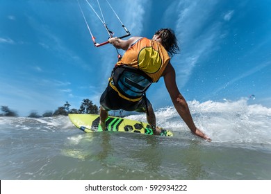 A Kite Surfer Rides The Waves