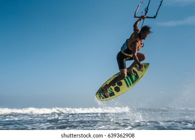 A Kite Surfer Rides The Waves