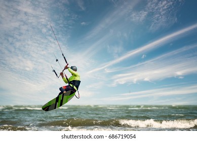 A Kite Surfer Rides The Waves