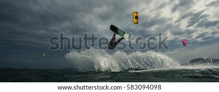 A kite surfer rides the waves