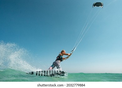 Kite Surfer Woman Rides With Kiteboard  In Transition