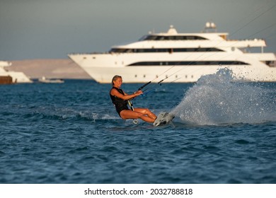 Kite Surfer Woman Rides With Kiteboard  In Transition