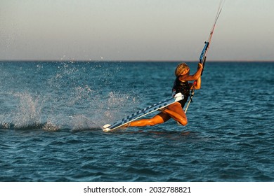 Kite Surfer Woman Rides With Kiteboard  In Transition