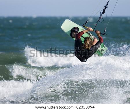 Kite surfing in Dorset. A kite surfer rides the waves.