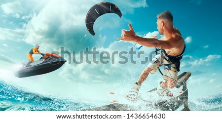 Kite surfing and water scooter in tropical ocean.
