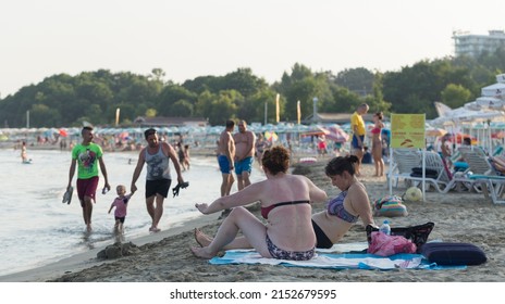 Kiten, Burgas Province, Bulgaria. 03.08.2021. Holidaymakers, on the Black Sea coast. People sunbathe on the beach and swim in the sea. Family idyll.