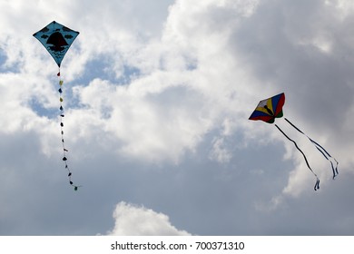 kites in sky with clouds