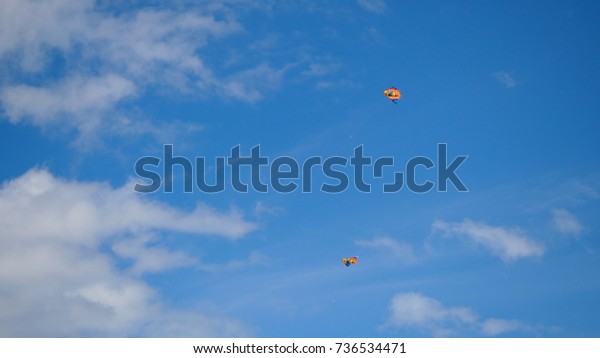 Kites in the sky. Colorful kites flying in\
blue sky. Under the blue sky flying\
kites