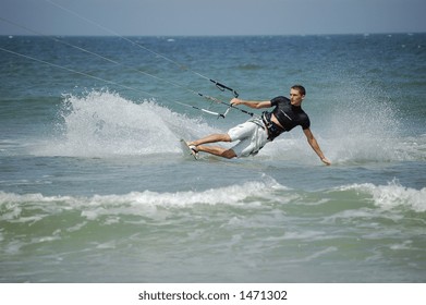 A Kitesurfer Leans Hard As He Turns The Corner At Ponce Inlet Beach, Florida