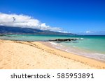 Kitesurfers at Kanaha Beach located in Kahului Bay near Kahului, the capital city of the island of Maui, Hawaii, USA. The beach is popular among kite surfers. Mountains of West Maui in the background.