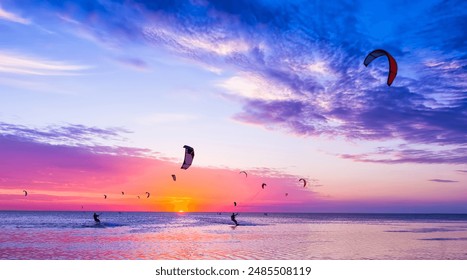 Kite-surfing against a beautiful sunset. Many silhouettes of kites in the sky. Holidays on nature. Artistic picture. Beauty world. - Powered by Shutterstock