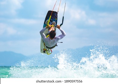 Kitesurfing, kiteboarding in exotic location, tropical island. Kitesurfer activities.