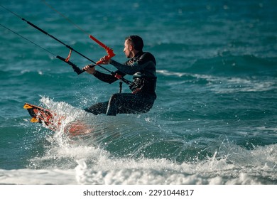 Kitesurfing. Surfers of all ages train in the Mediterranean. Israel, Ashkelon, January 2023 Training continues. Sport, health, recreation concept