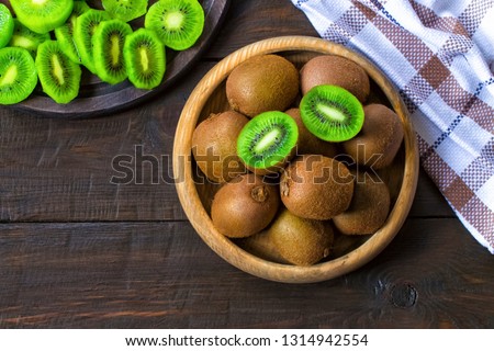 kiwi fruit in a wooden bowl close-up.  kiwi is the top view. background with kiwi.
