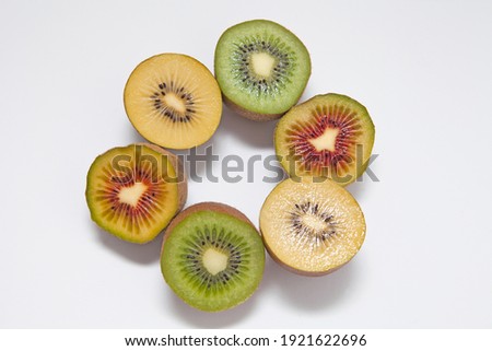 Kiwi Fruits in three different colors: Red Kiwi, Gold Kiwi and Green Kiwi isolated on white background. 