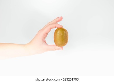 Kiwi In The Hand Of A Woman On A White Background