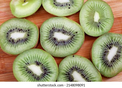 Kiwi Slices On Wooden Chopper Board

