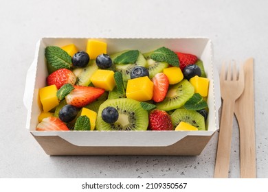 Kiwi, Strawberry, Blueberry, Mango Fruit Salad In Cardboard Container. Food Delivery To Home And Office, Healthy Diet Plan Concept