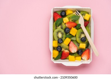 Kiwi, strawberry, blueberry, mango fruit salad in cardboard container. Food delivery to home and office, healthy diet plan concept - Shutterstock ID 2109350600