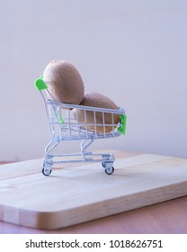 Kiwifruit In Cart On Wooden Table Background,