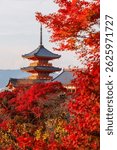 Kiyomizudera temple with red maple leaves in autumn at sunset in Kyoto, Japan. The temple vibrant red and orange pagoda stands out with colorful fall foliage enhance scenic beauty.