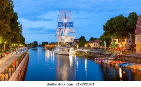 KLAIPEDA, LITHUANIA - 04 JULY 2022 Ship-restaurant Meridian is docked on the Danes river. Night scene of Klaipeda old town district. Klaipeda, Lithuania.