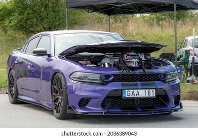 Klaipeda, Lithuania - September 04 2021: Purple Color Dodge Charger SRT Hellcat Stands On The Parking Lot With The Hood Open After The Drag Race.