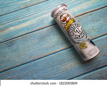 Klang, Malaysia - 18 September 2020 : PRINGLES Mystery Flavour Potato Chips Tube On The Wooden Background.Selective Focus.

