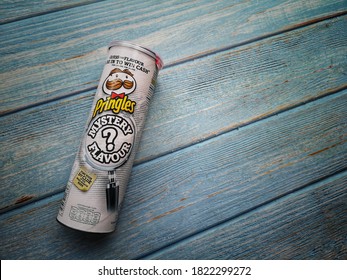 Klang, Malaysia - 18 September 2020 : PRINGLES Mystery Flavour Potato Chips Tube On The Wooden Background.Selective Focus.

