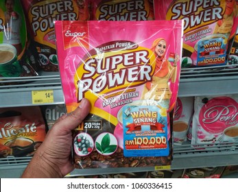 Klang , Malaysia - 1st April 2018 : Hand hold a packet of SUPER POWER Mix Coffee Kacip Fatimah with colegen in the supermarket.
