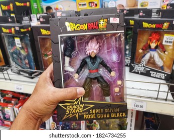 Klang, Malaysia - 25 September 2020 : Hand Hold A Boxed Of Dragon Ball Super Saiyan Rose Goku Black Toy Character For Sale In Supermarket Store With Selective Focus.

