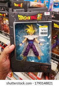 Klang, Malaysia - 30 July 2020 : Hand Hold A Boxed Of Dragon Ball Super Saiyan Gohan Toy Character For Sale In Supermarket Store With Selective Focus.  